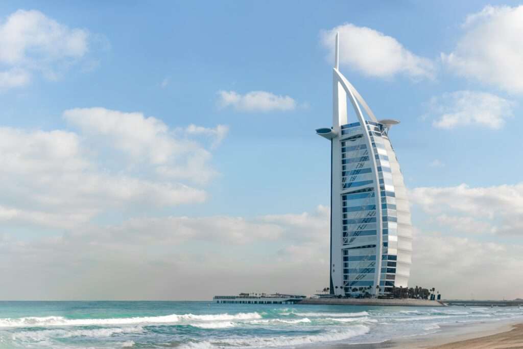 Stunning view of Burj Al Arab with a serene beach setting in Dubai, UAE.